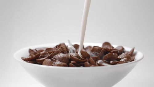 Milk is Poured into Chocolate Cereal Bowl