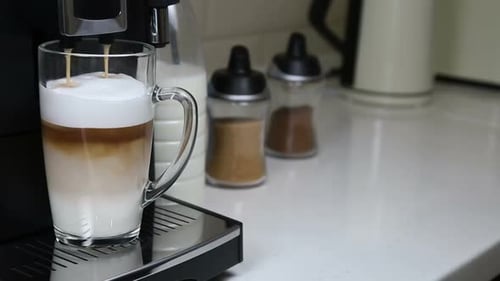 Espresso Pouring Into a Glass of Milk