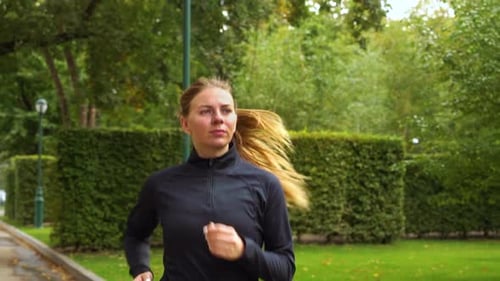 Woman jogging in park in the morning
