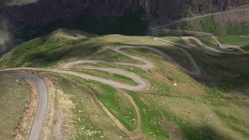 Cars passing through curve in mountainous road. Mountain serpentine road