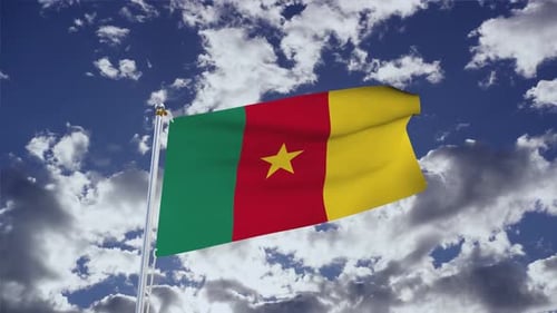 Waving Flag of Cameroon Against Blue Sky