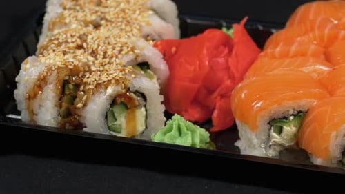 Sushi Rotates on Plastic Box. Japanese Sushi Roll Set Philadelphia, California