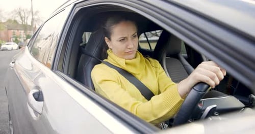 Woman Waits in Car on Suburban Street