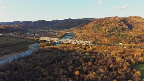 Railroad Bridge Over River in Highland with Colorful Trees