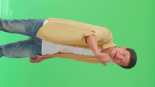Asian Man Threatening With Finger In The Green Screen Studio