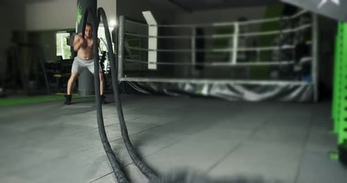 Shirtless Man Working Out with Battle Ropes