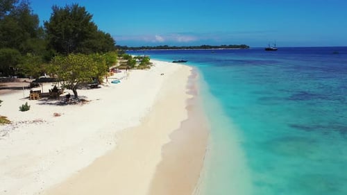 Beautiful fly over clean view of a white sandy paradise beach and aqua turquoise water background