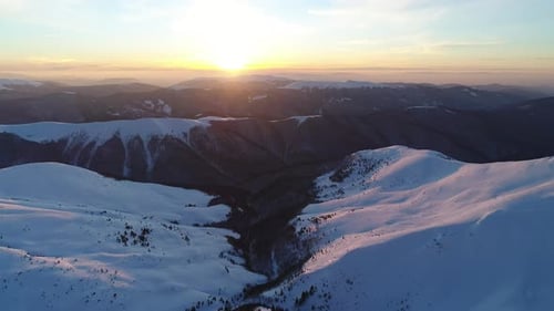 Snowy Mountains at Sunset Aerial View