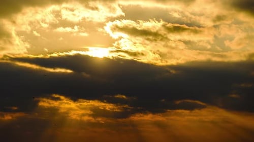 Amazing Sunset Through the Cumulus Clouds in the Orange Sky. Majestic Timelapse