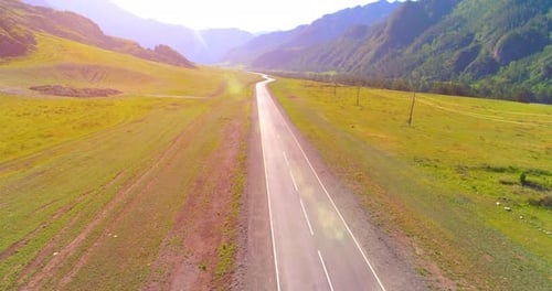 Flight Over Mountain Asphalt Highway Road and Meadow