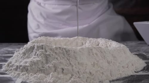 Egg Dropped into Flour for Baking Ingredients