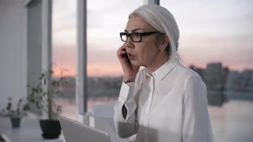 Middle-Aged Company Manager Working Overtime Alone in Office