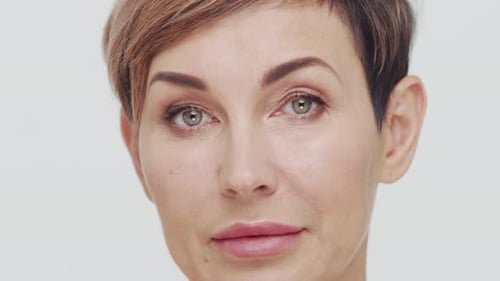 Close-up of middle aged mature woman over white background.