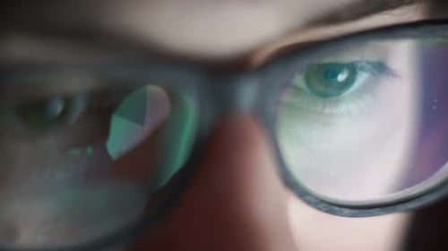 Person Wearing Glasses with Screen Reflection Close-Up