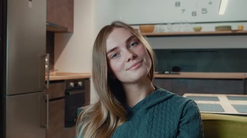Smiling Woman with Brown Hair in Modern Kitchen