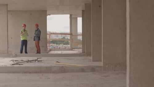 Workers Talking on Construction Site