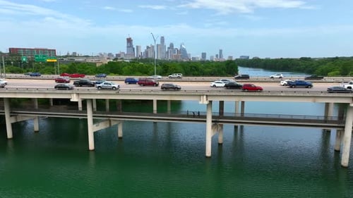 Lifestyle in American city life. Congested traffic jam on highway bridge over river. Pedestrians exe