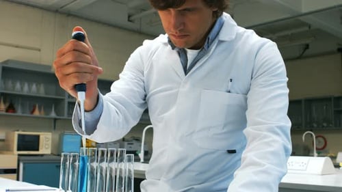 Scientist Working with Pipette and Test Tubes in Lab