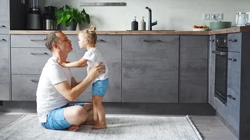 Loving Father Kissing his Daughter in Kitchen