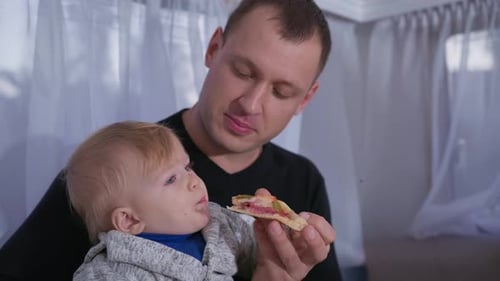 Baby Feeding Fast Food Father Feed Male Toddler Pizza During Family Travel in Trailer