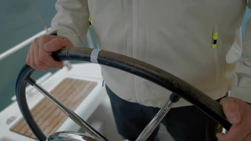 Man's Hands on Boat Steering Wheel Close Up