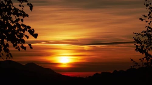 Setting sun, blurred clouds