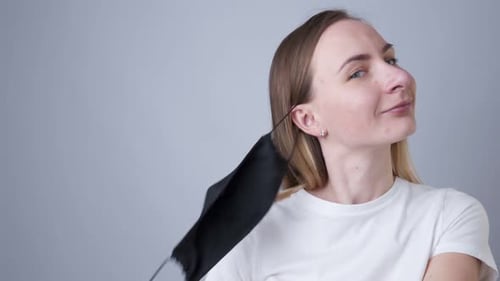 Close-up Portrait of a Woman Removes a Black Medical Mask During the Quarantine of the COVID-19