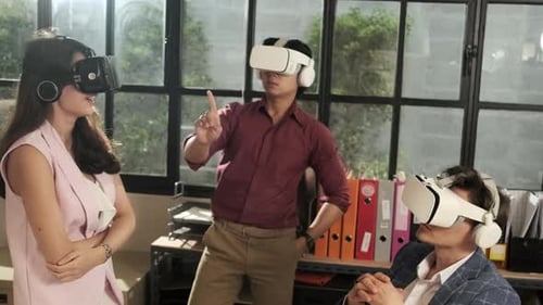 Workers are using VR headsets to visualization cyberspace at business office.