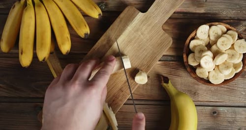 Slicing Banana on a Cutting Board Top-Down View