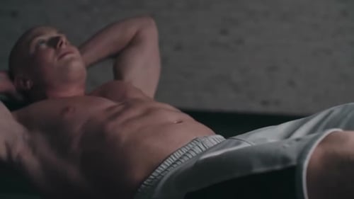 Young Man Doing Sit Ups in Gym