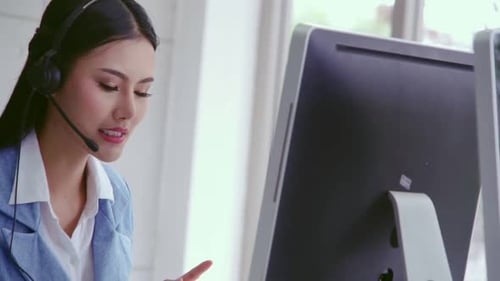 Customer Support Agent or Call Center with Headset Talking to Customer on Phone