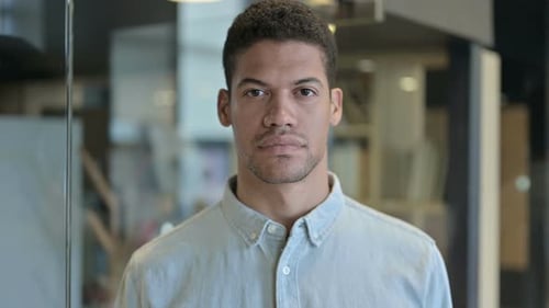 Portrait of Serious Young Adult Man in Office