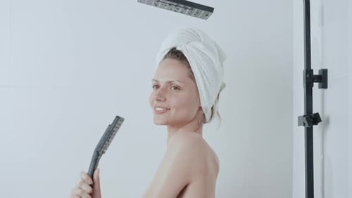 Smiling Woman Singing in Shower with Handheld Head