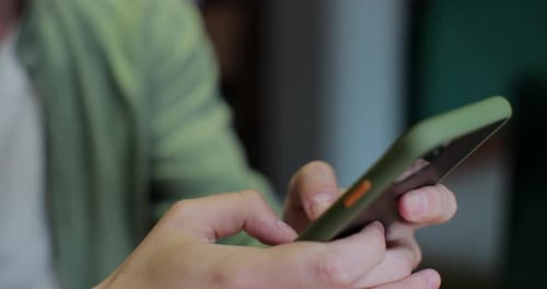 Close Up of Person Using Smartphone Indoors