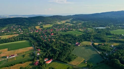 Aerial View of Countryside Area with Village and Mountains