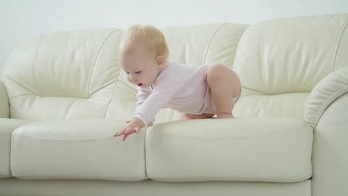Adorable Baby Exploring Couch in Bright Home Interior