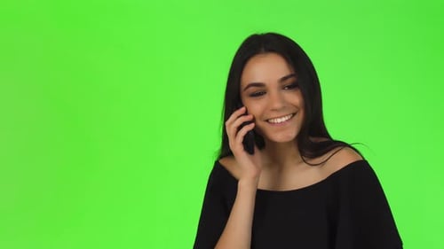 Woman Talking on Cell Phone in Front of Greenscreen
