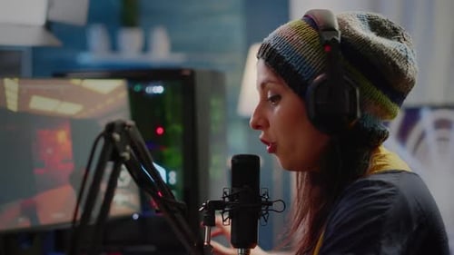 Woman Gaming and Speaking Into Microphone in Studio