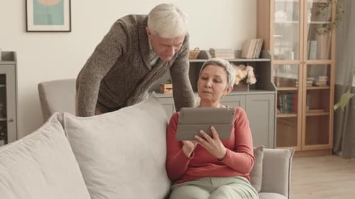 Senior Couple Using Tablet at Home Together