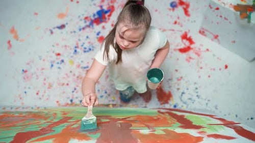 Girl Painting on Canvas in a Colorful Art Studio