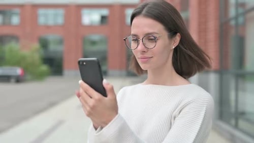 Woman Using Smartphone in Urban Environment