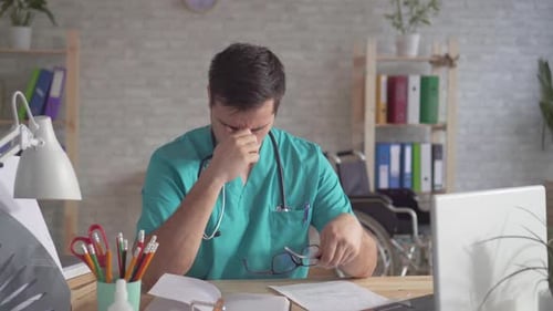 Close Up Portrait of a Man Doctor Overtire at Work