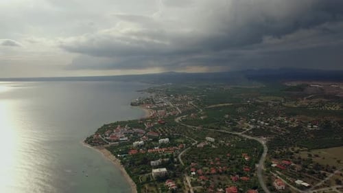 Flying Over the Town on Coast. View with Overcast Sky, Greece