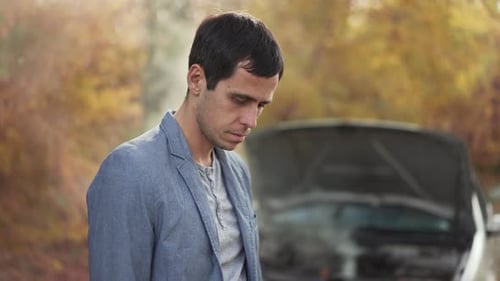 Adult by Car with Mechanical Problems in Autumn