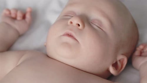 Newborn Baby Boy Having Sweet Dreams at Home