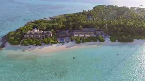 Aerial view above of luxury resort during the sunset, Maldives island.