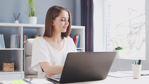 Young Woman Works at Home Office Using Computer.