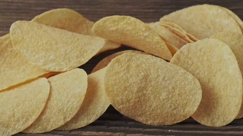 Close Up of Potato Chips on Wooden Surface