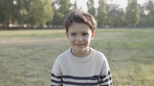 Smiling Child in Park on a Sunny Day