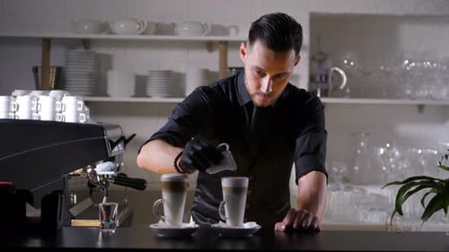 Stylish Barista Pouring Cream into Coffee Drinks